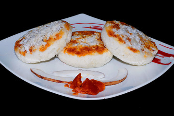 pancakes with red caviar on plate isolated on white