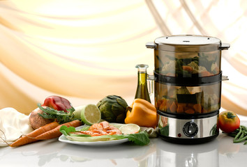 Food steamer filled up with vegetables, on white table	