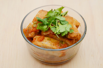 Fishcake fried with tomato sauce in bowl