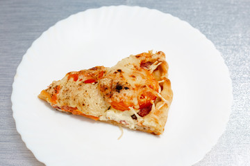 slice of fresh pizza on a white plate