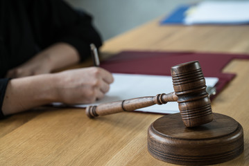 justice and law concept. Female judge in a courtroom on wooden table and Counselor or Male lawyer...