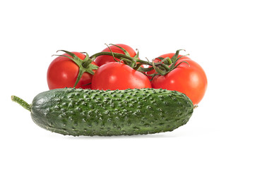 green cucumber and red tomatoes on a branch  isolated on a white background