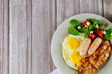 Dish with breakfast meal on wooden background.