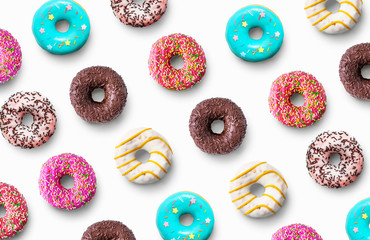 Delicious glazed donuts pattern on a white background. Top view. Flat lay.