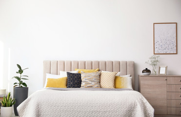 Stylish interior of contemporary room with comfortable bed