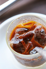 Iced coffee in glass with spoon