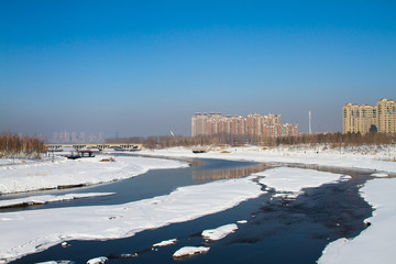 Melted snow covered frozen lake river in spring