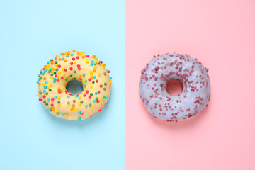 Delicious glazed donuts on color background, flat lay