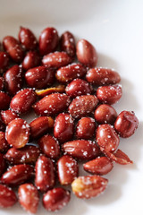 Roasted and salted peanuts on plate 