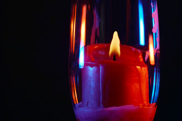 Candle with smoke and flame photographed in the studio with color foils before the flashes