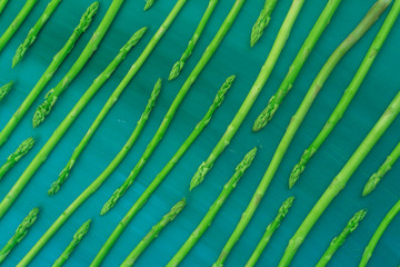 Fresh green asparagus pattern, top view. Food background asparagus flat lay pattern