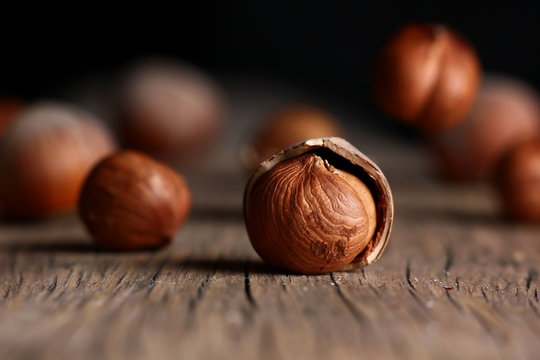 hazelnut in a shell close-up on a textured wooden background