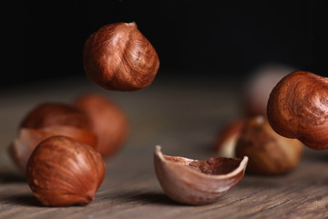 hazelnuts falling on a wooden table