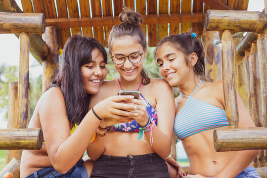 Group of young girl friends having fun with a smartphone 