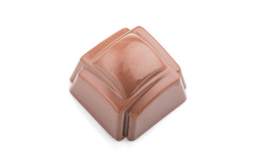 Single chocolate candy isolated on white background. side view.