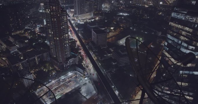 Bangkok street life at night - Bird view to Thong Lor BTS Skytrain Station - Modern big city life - Bangkok downtown traffic - 4K high resolution wallpaper