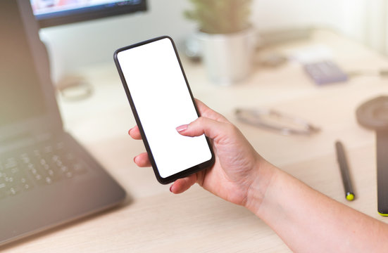 Mockup image of hand holding mobile phone with blank white screen