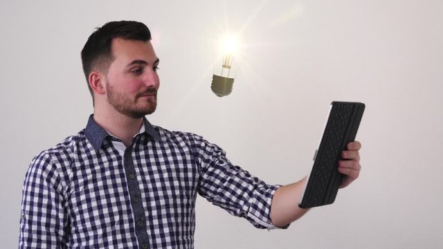 Business man with a tablet stands against a white background. Buzzwords about work fly past him until he can think of a solution.