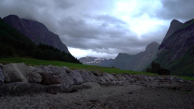 Dark clouds moving over the mountain valley on the evening - high norwegian mountains