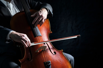 Cello player or cellist performing in an orchestra background - obrazy, fototapety, plakaty