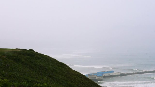 Nice footage of cliffside on the ocean, waves crashing on a cloudy day in Lima, Peru.