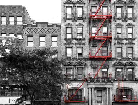 Red Fire Escape On The Exterior Of An Old Building In Black And White - Manhattan, New York City