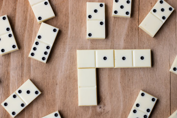 Dominoes. Old domino bones lay on a wooden brown table