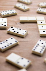 Dominoes. Old domino bones lay on a wooden brown table