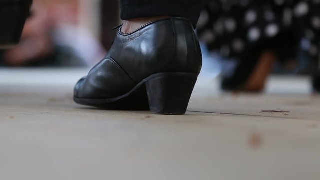 Close up of flamenco dancer feet during dance presentation with very shallow depth of field