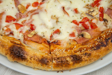 pizza with peppers and mushrooms, sesame and olives
