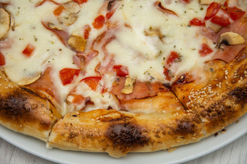 pizza with peppers and mushrooms, sesame and olives