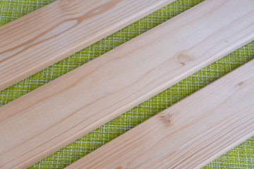 Light wooden DIY boards on green background