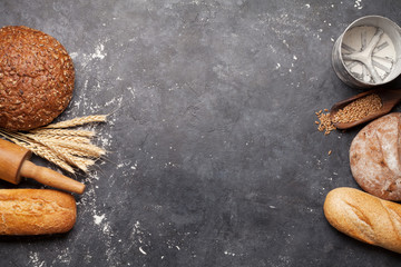 Various bread with wheat, flour and cooking utensils
