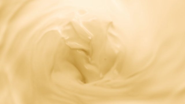 Super Slow Motion Shot of Swirling Yellow Milky Wortex at 1000fps.