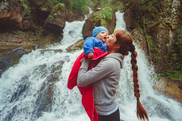 mother with child near the waterfall