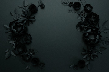 Black paper flowers on Black background. Cut from paper.
