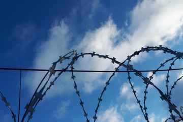 barbed wire against the blue sky