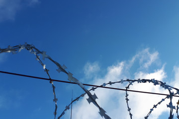 barbed wire against the blue sky