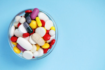 A bowl with colorful medicine pills	