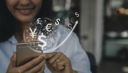 Businesswoman uses phone,world currencies, wallet cryptocurrency on virtual screen, fintech...