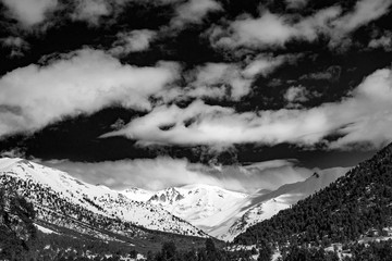 Snowy B&W mountain top with cloudy sky