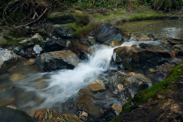 Long exposure photograph of the water in the Monachil River, in Los Cahorros. Monachil, Granada, Spain.