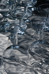 upright glass glasses with gray tablecloth in focus, focus and sharpness on individual locations