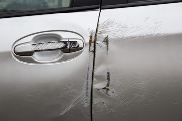Car door with scratches after a traffic accident
