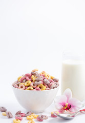 Corn cereal breakfast flake in children cups and milk is a healthy breakfast that is good for your body every day on a white background.