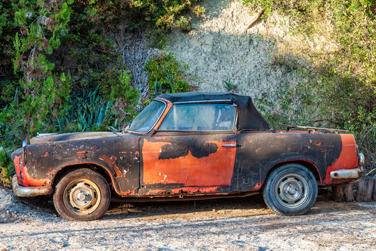 Old vintage rusty car abandoned