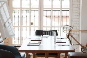 Up-to-date office boardroom interior with laptops on table
