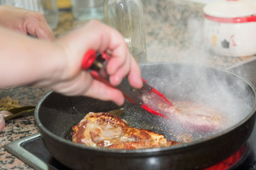 Hands Cooking Beef at home.