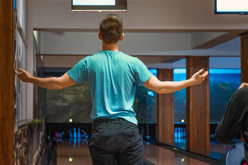 Young man being angry over bad throw with bowling ball