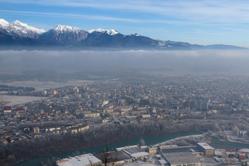KRANJ, SLOVENIA - JANUAR 4, 2011: Morning fog above town Kranj in Slovenia and a river Sava. Panoramic view.